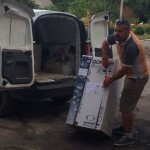 Unloading boilers at the orphanage's warehouse