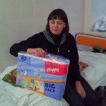 Vegerak Anya's grandmother accepting diapers while Anya is getting two surgeries